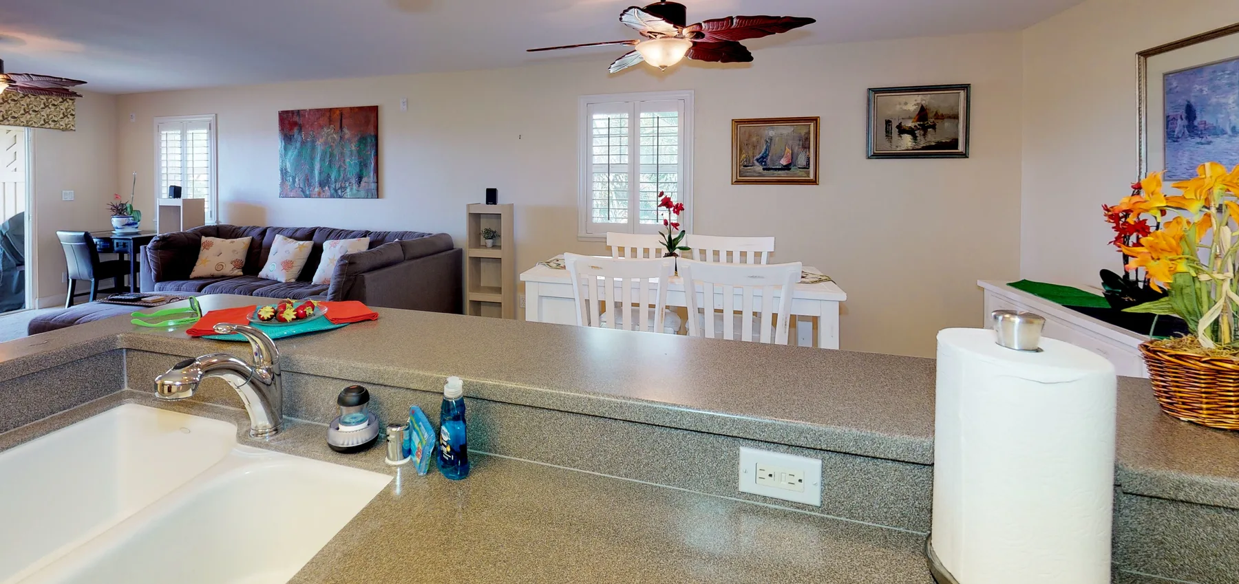Open-plan living and dining area with a kitchen counter in the foreground.