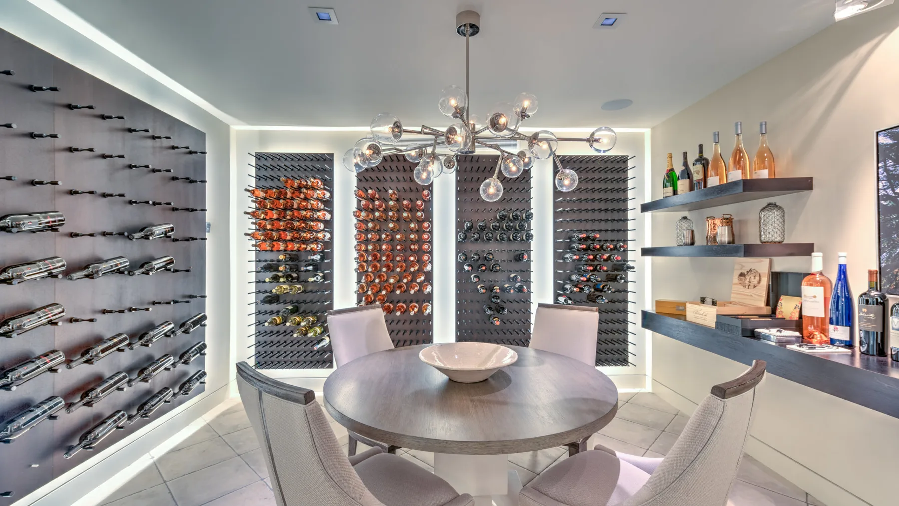 A wine room with bottle displays lining the walls around a central tasting table.
