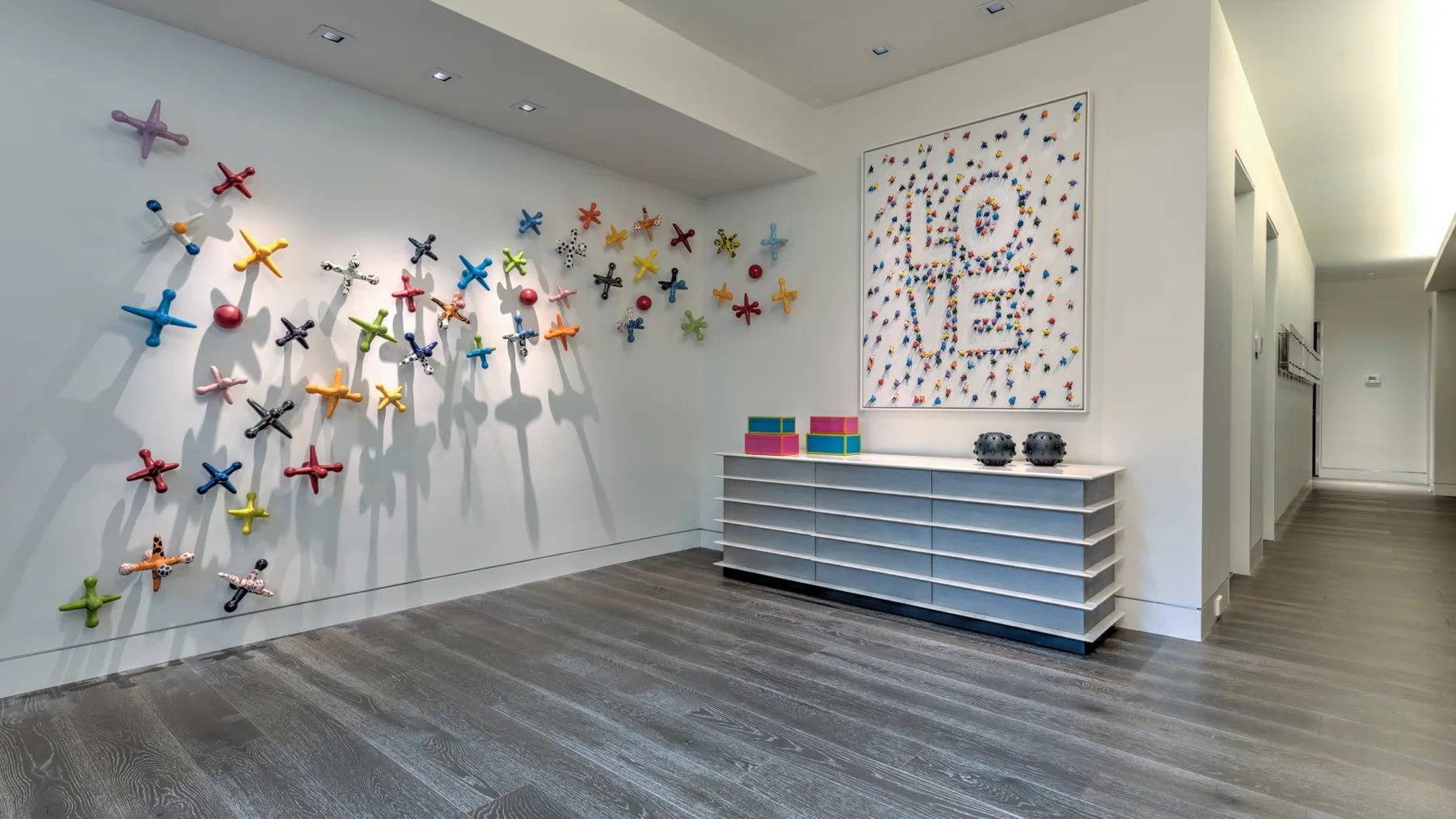 A bright hallway features colorful airplane decorations and a framed “LOVE” artwork.