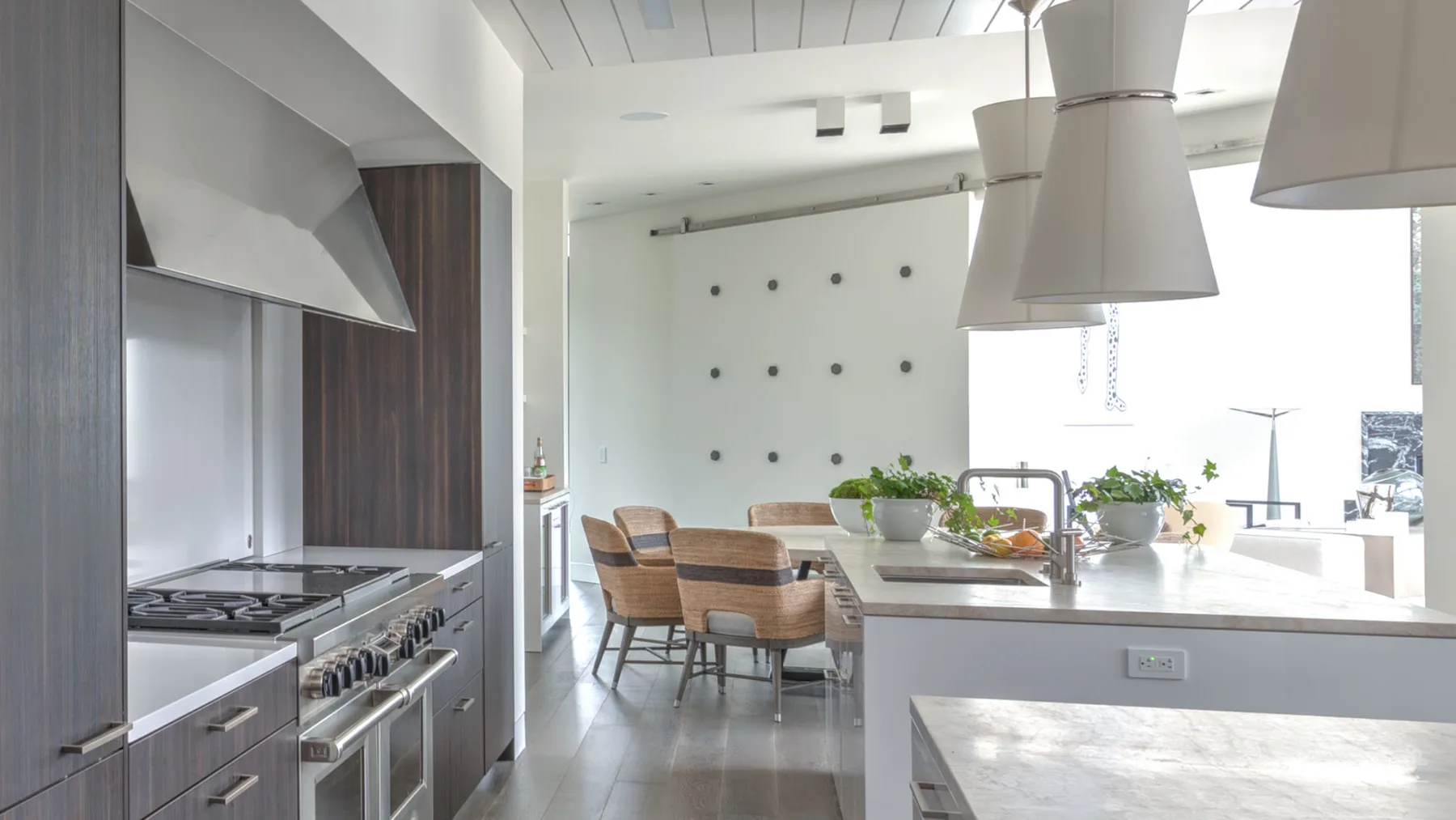 A bright kitchen and dining area with a large island and dining table.