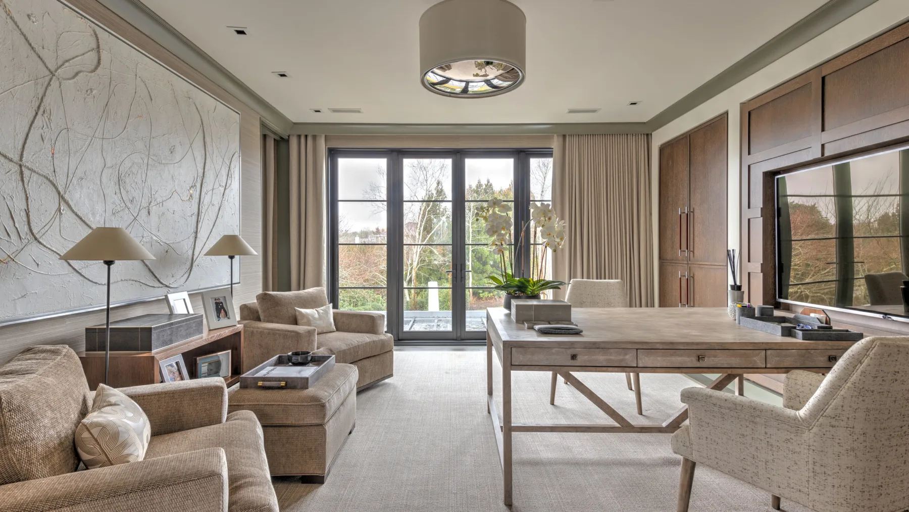 A bright living room with seating arranged around a low wooden table.