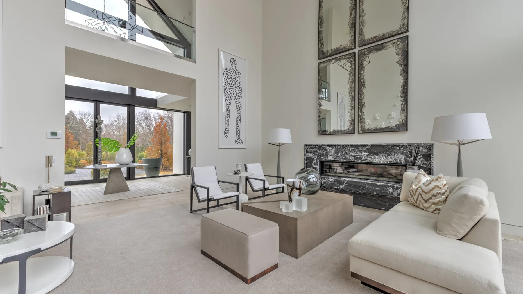 A bright modern living room with seating arranged around a low coffee table.