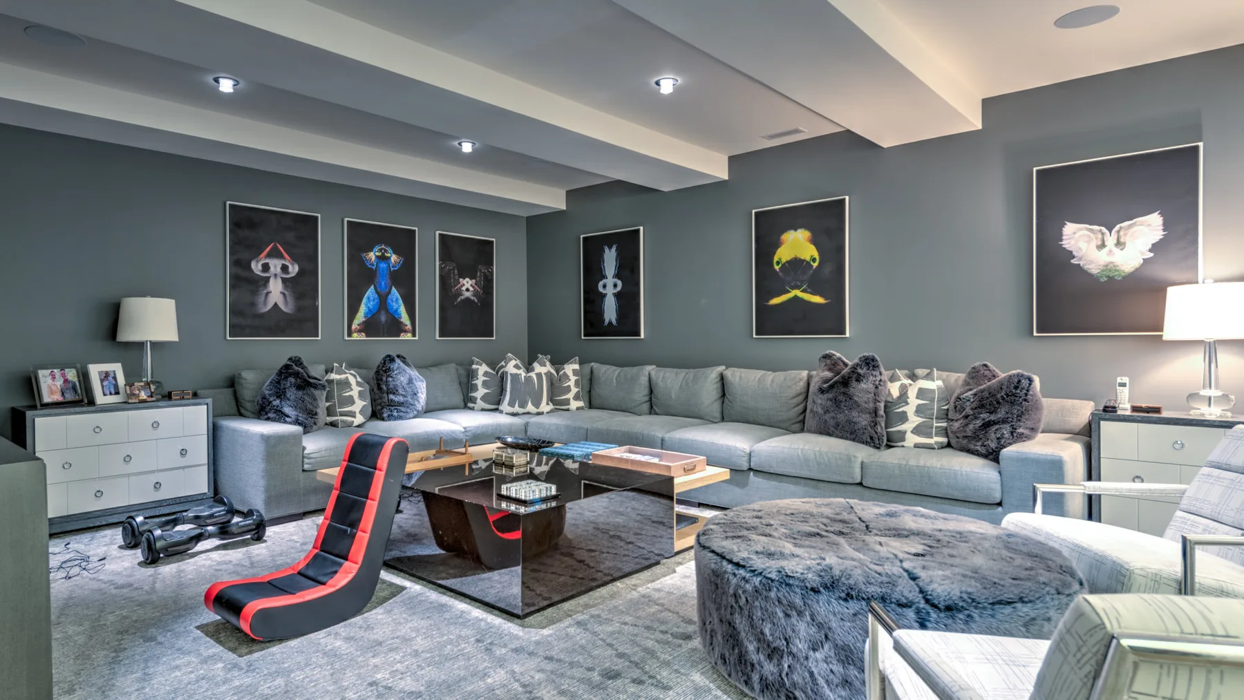A modern living room with a large sectional seating area and a low coffee table.