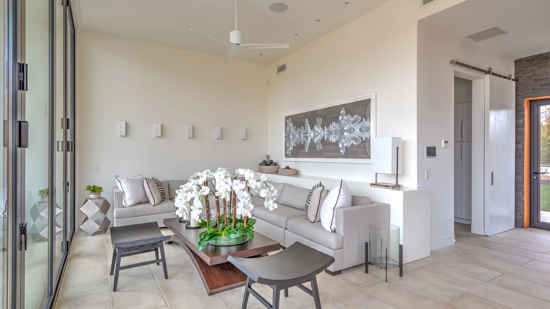 A bright living room with sectional seating and a low coffee table.