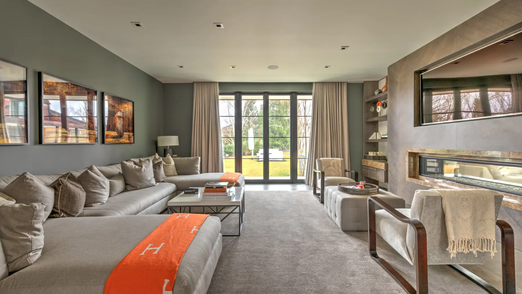 A living room with seating, a coffee table, and large glass doors.