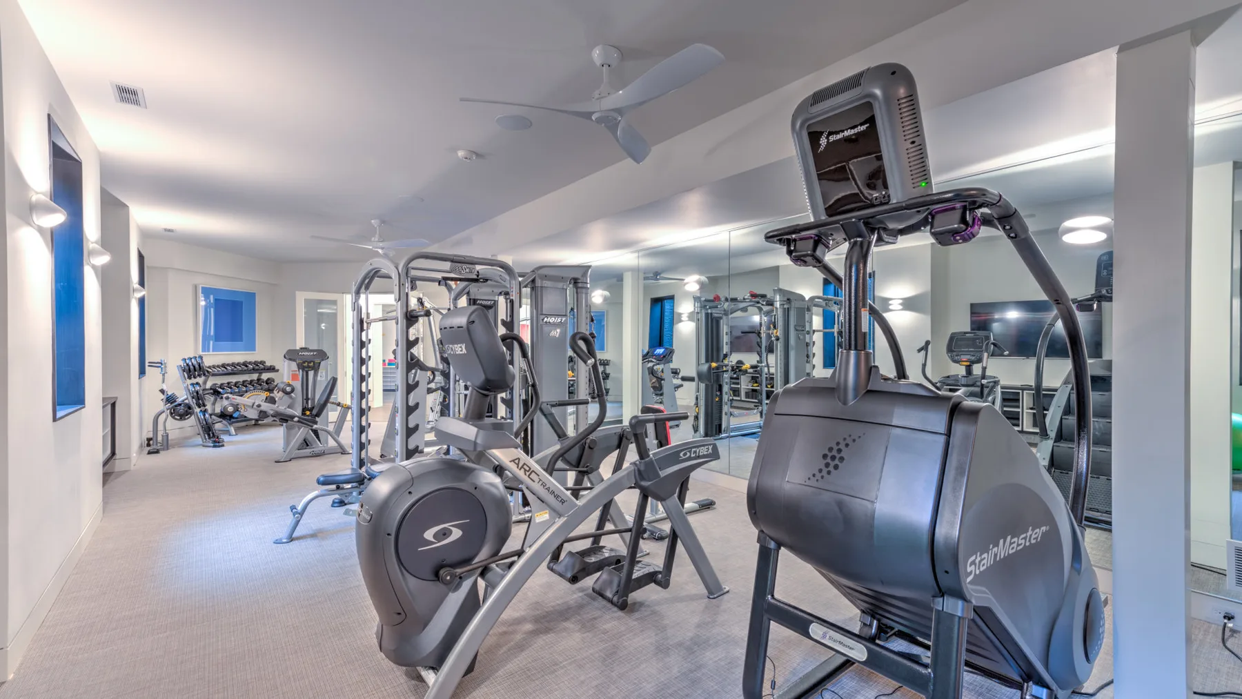 A gym with exercise machines and weight-training equipment.