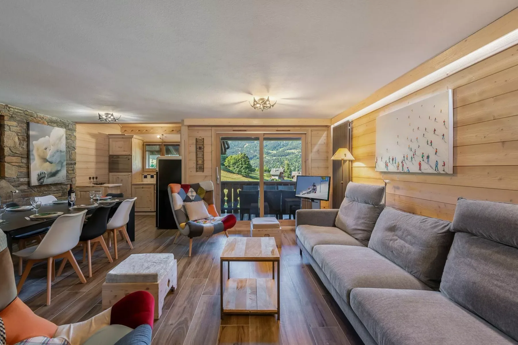 A living room with a sectional sofa and dining area beside sliding glass doors.