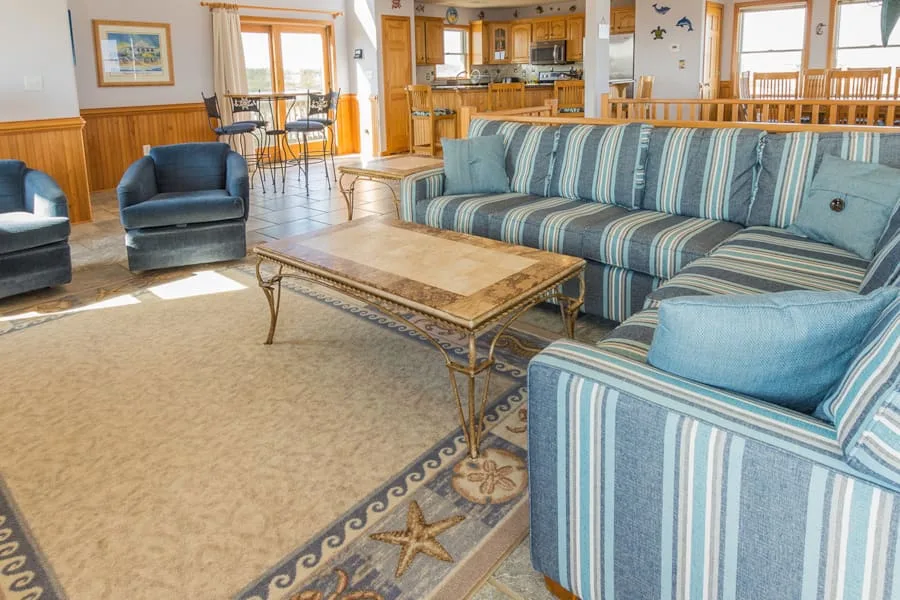 A living room with striped seating and a coffee table.