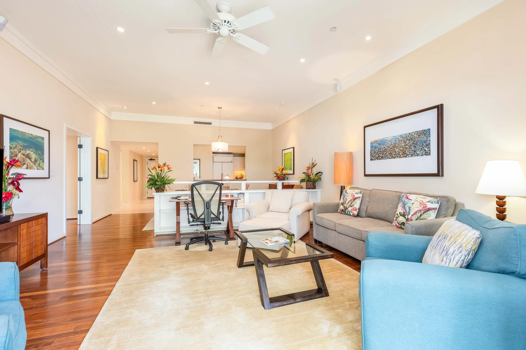 A bright living room with seating, a coffee table, and a dining area.