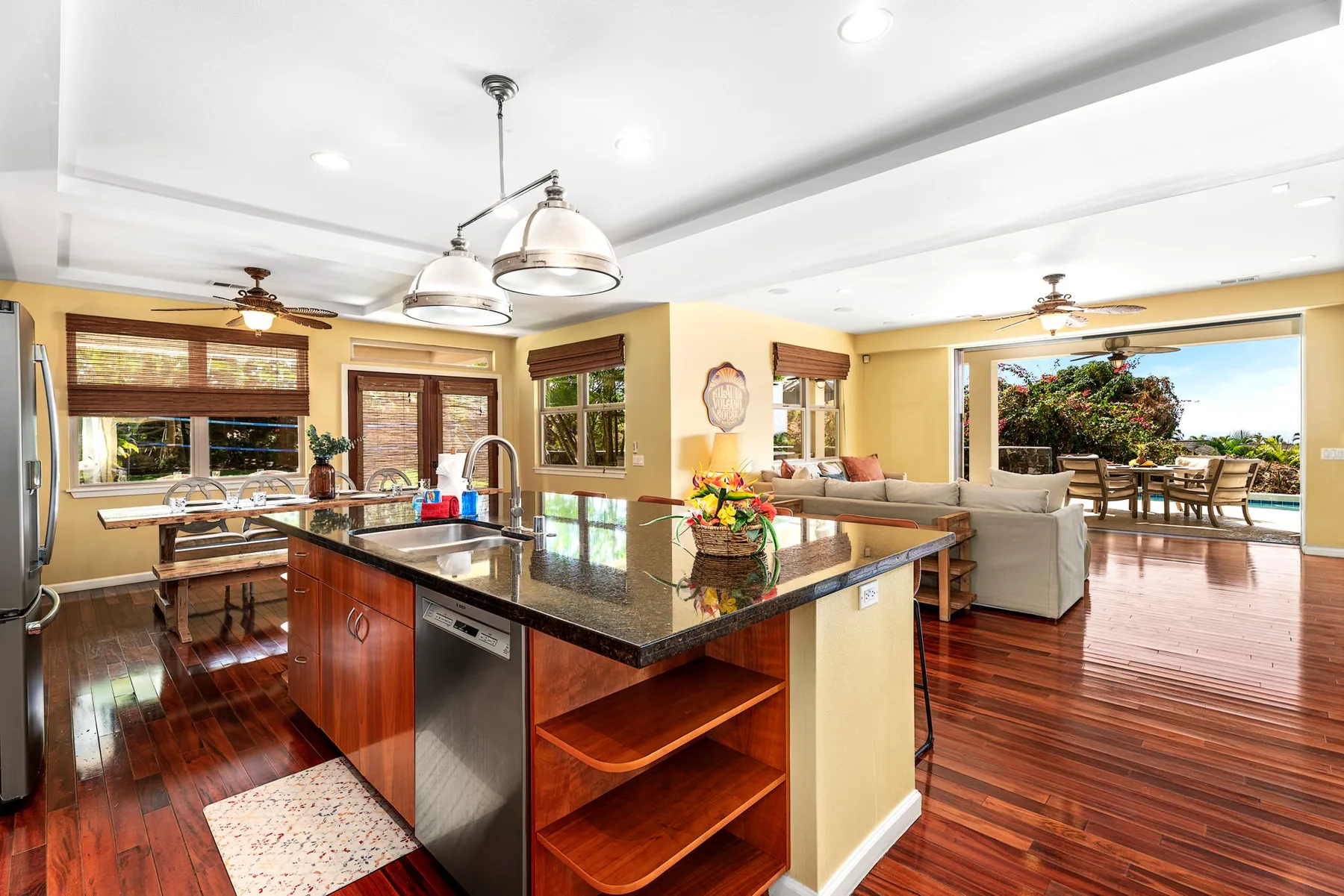 An open-plan kitchen and living area with a central island and seating.