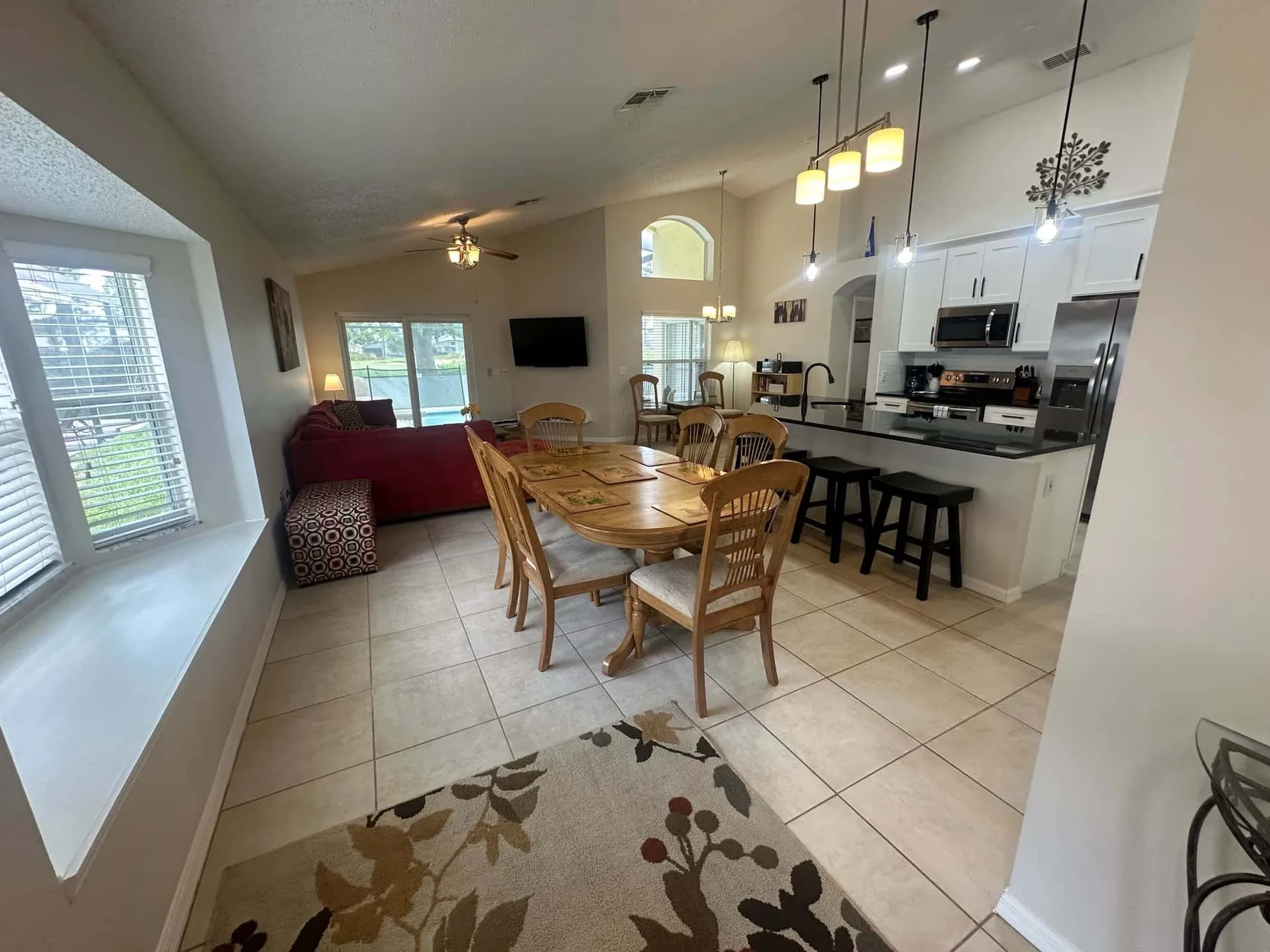 An open-plan living and dining area with a kitchen counter and dining table.
