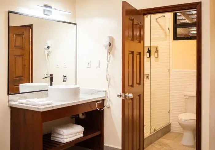 Bathroom with sink, toilet and mirror.