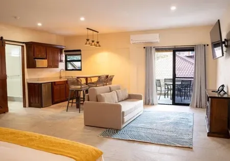 Living area with couch, television and sliding glass doors.