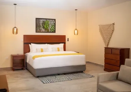 Hotel room with king bed and couch.