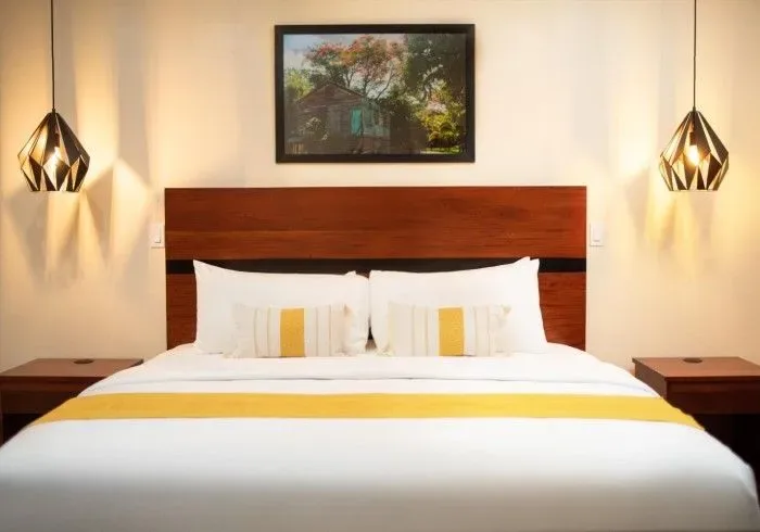 Hotel room with wall picture above the bed.
