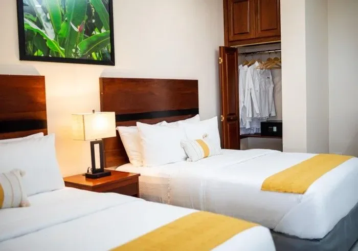 Hotel room with two beds and a wall picture.