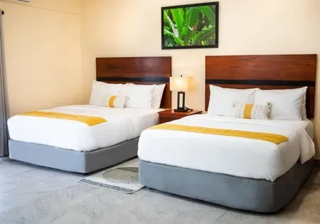 Hotel room with two beds and a wall picture.