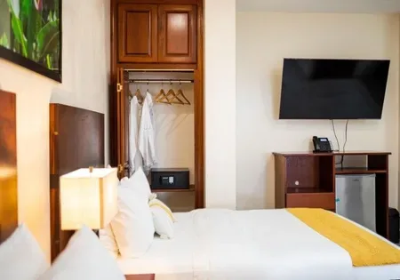 Hotel room with bed and television.