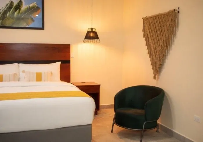 Hotel room with a bed and chair.