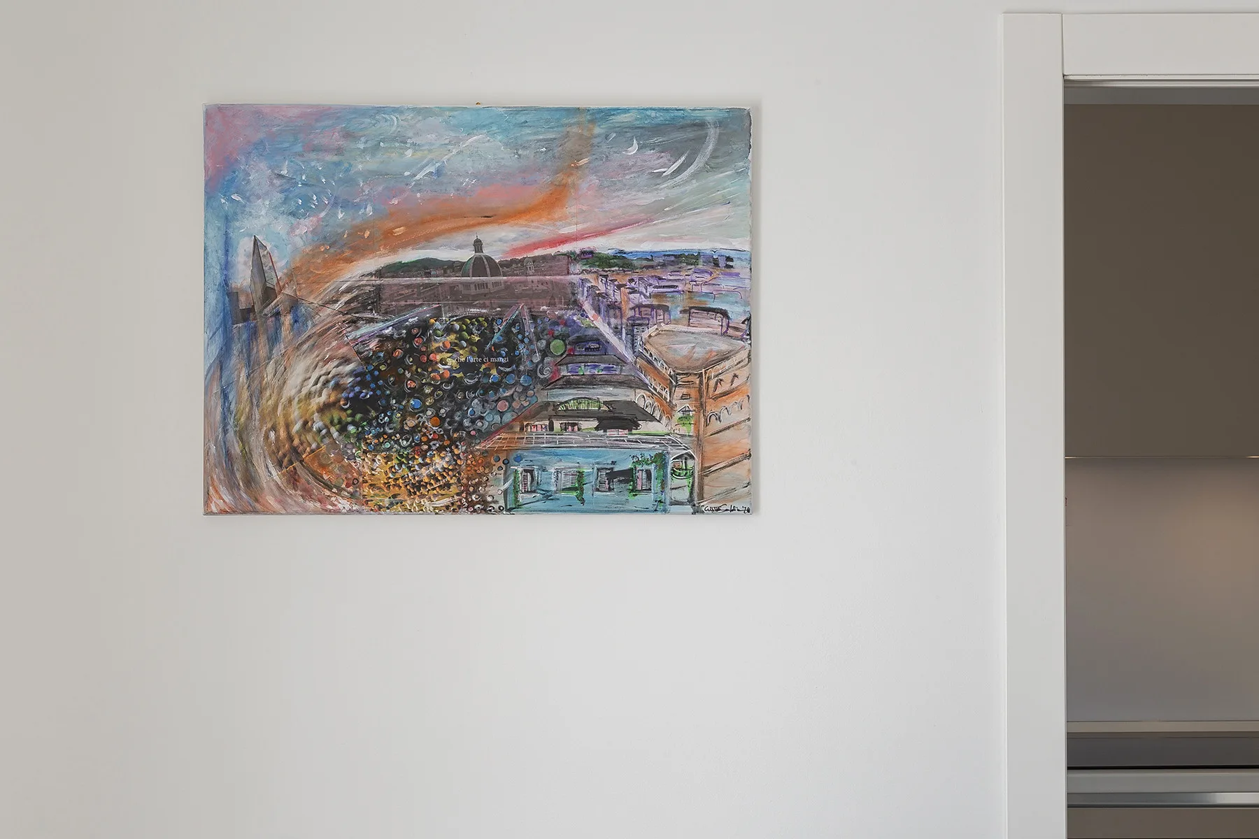 A colorful abstract painting hangs on a white wall beside an open doorway.