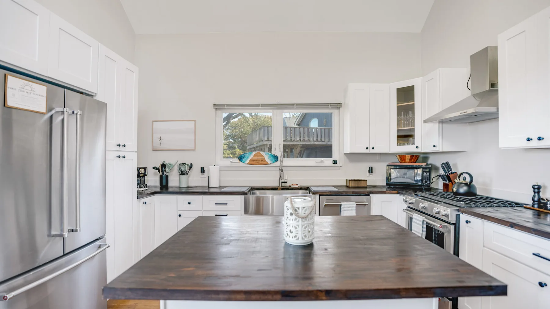 A bright kitchen with white cabinets and a large central island.