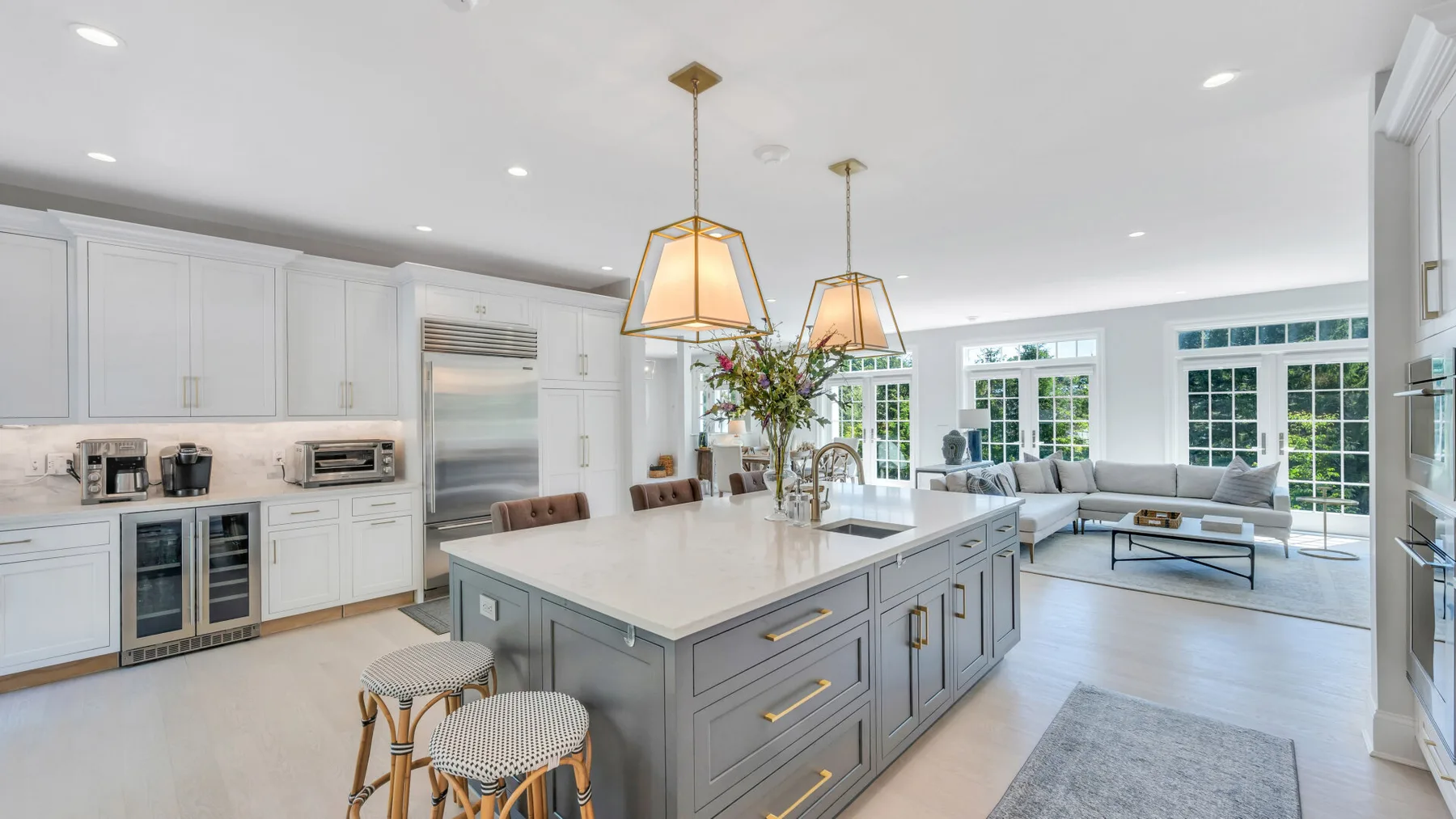 A bright open-plan kitchen and living area with a large central island.