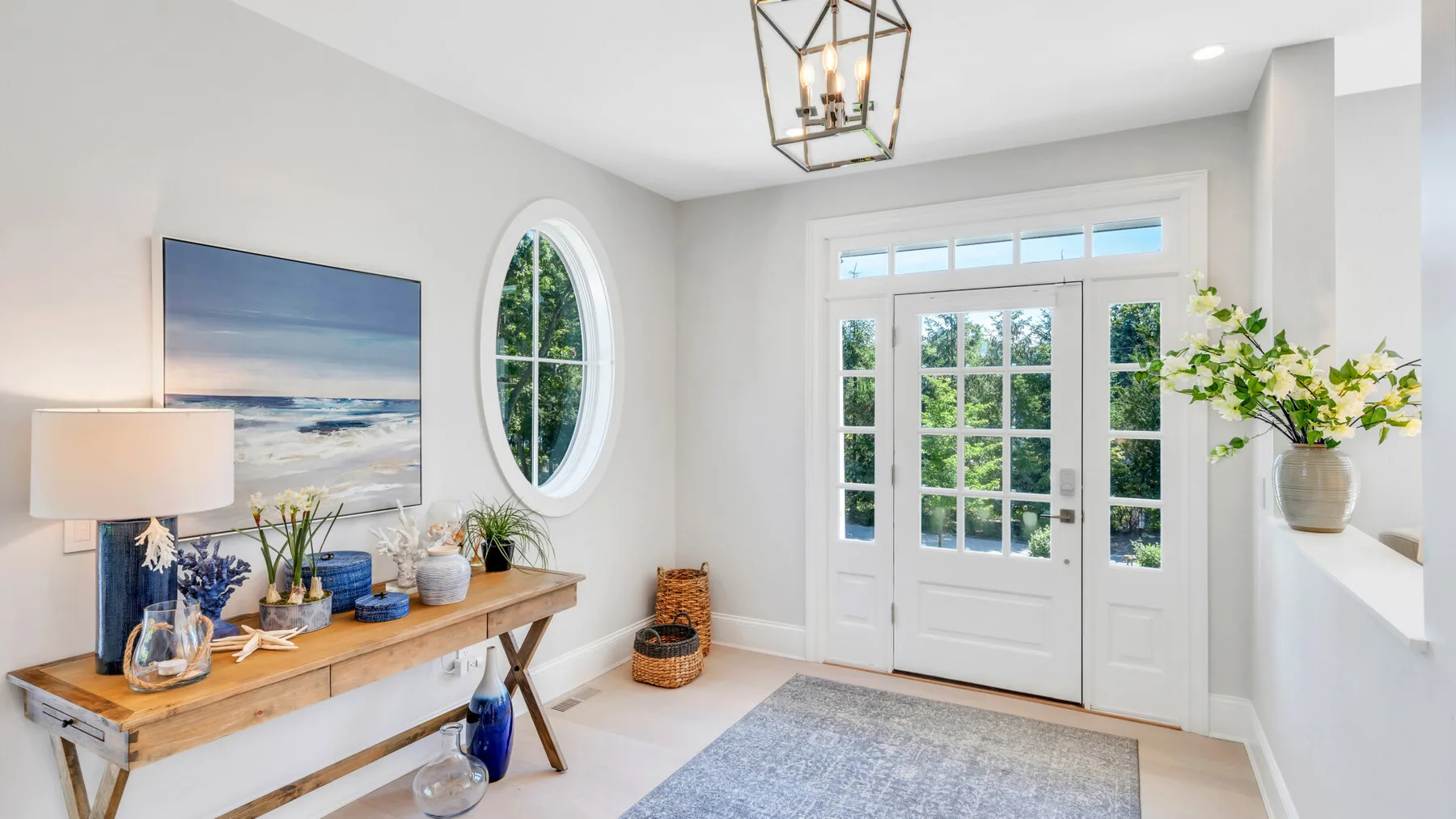 A bright entryway with a glass-paned front door and a console table.