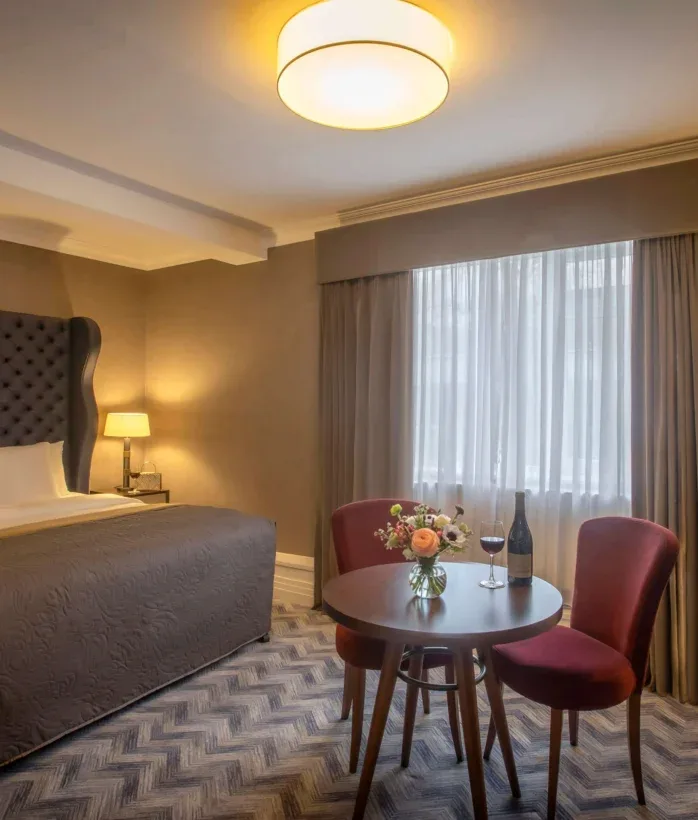 Hotel room with table set for two.