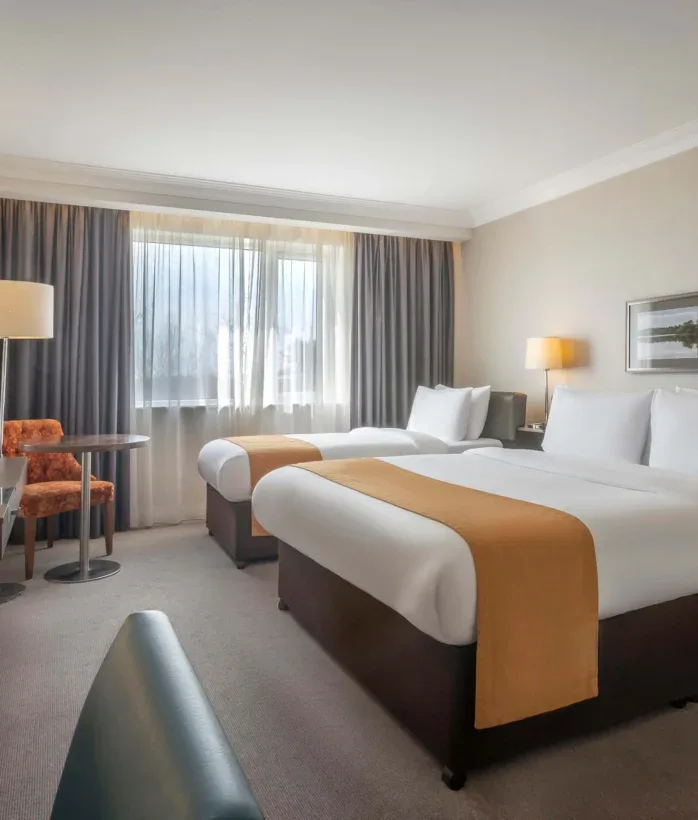 Hotel room with twin beds and seating.
