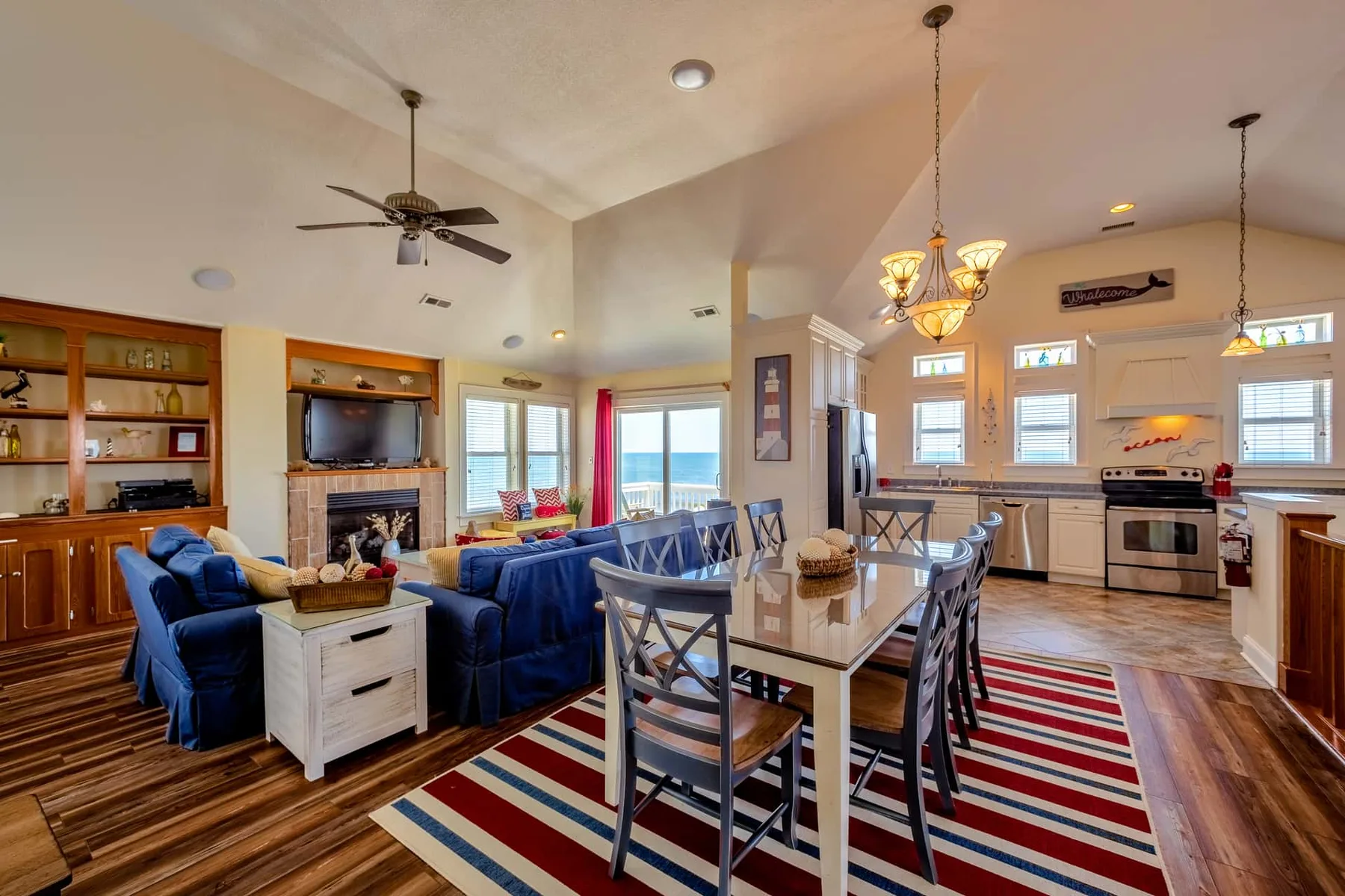 An open-plan living and dining area with blue seating and a long dining table.
