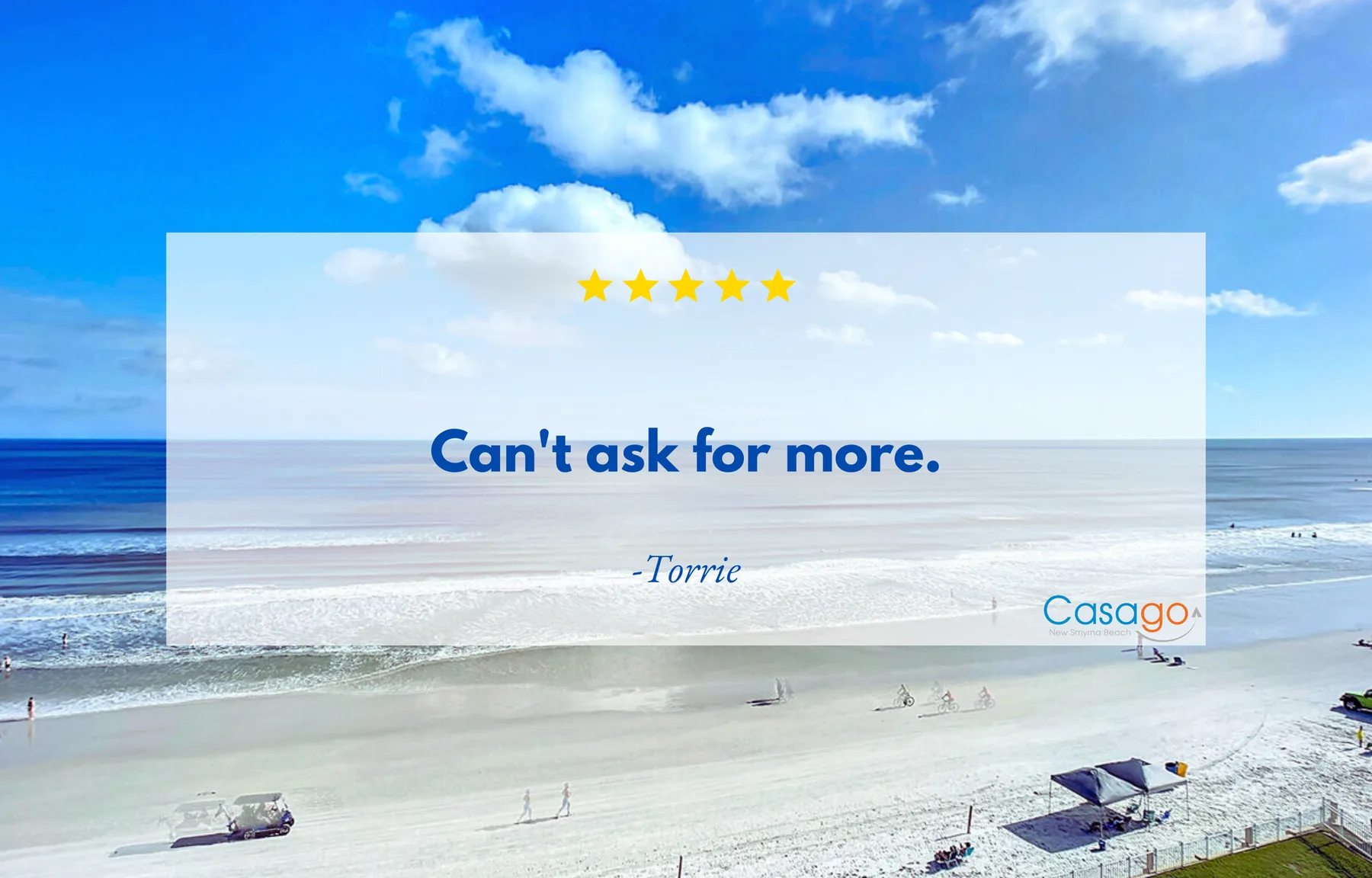 Beach scene with ocean waves, sandy shore, and a bright blue sky.