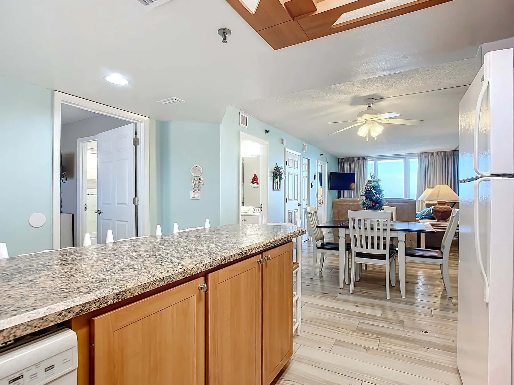 An open kitchen and dining area with a long counter and table.