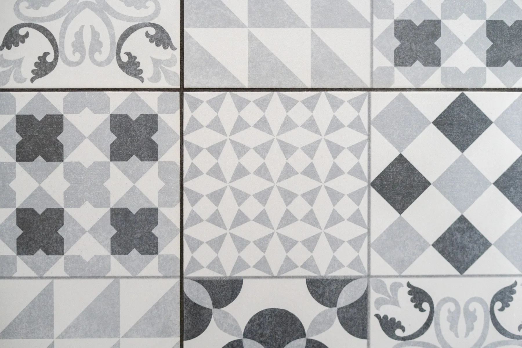 A close-up of patterned gray and white floor tiles.