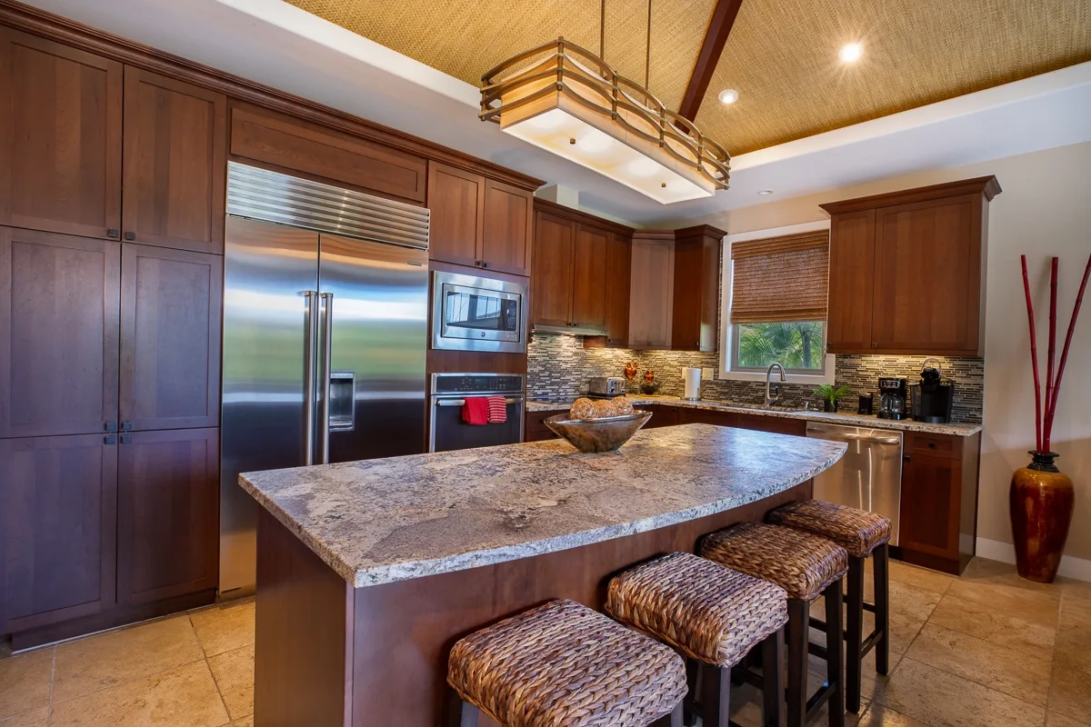 Una cocina amplia con gabinetes de madera oscura y una gran isla central.