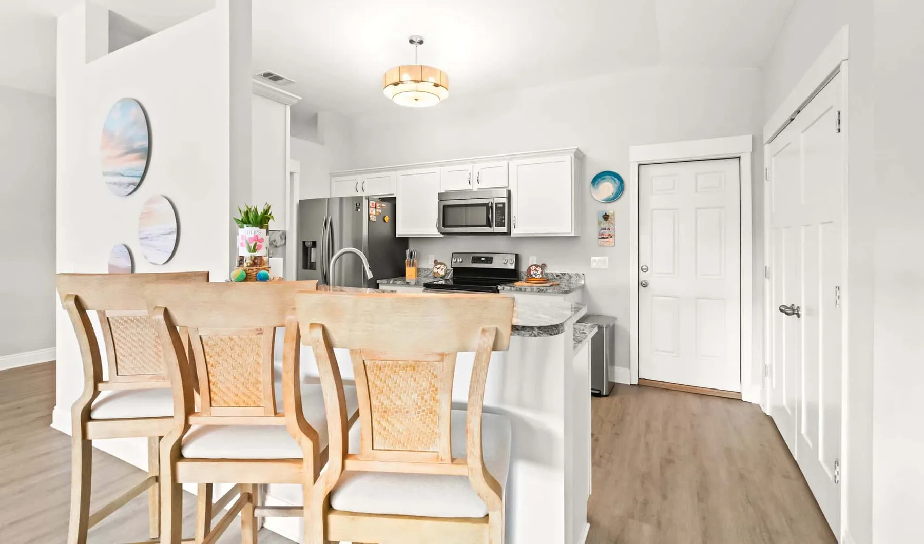 A bright kitchen and dining area with a table and seating.