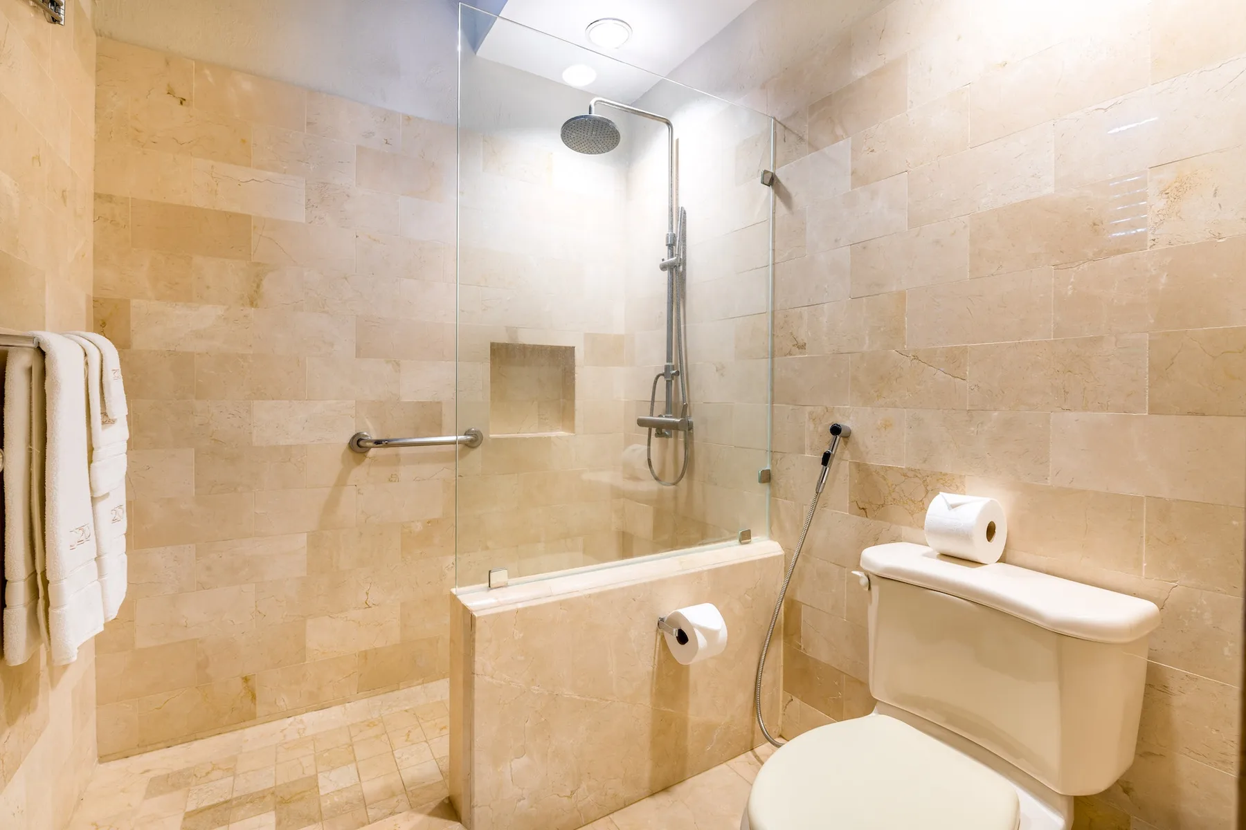 Un baño alicatado con bañera, ducha e inodoro.
