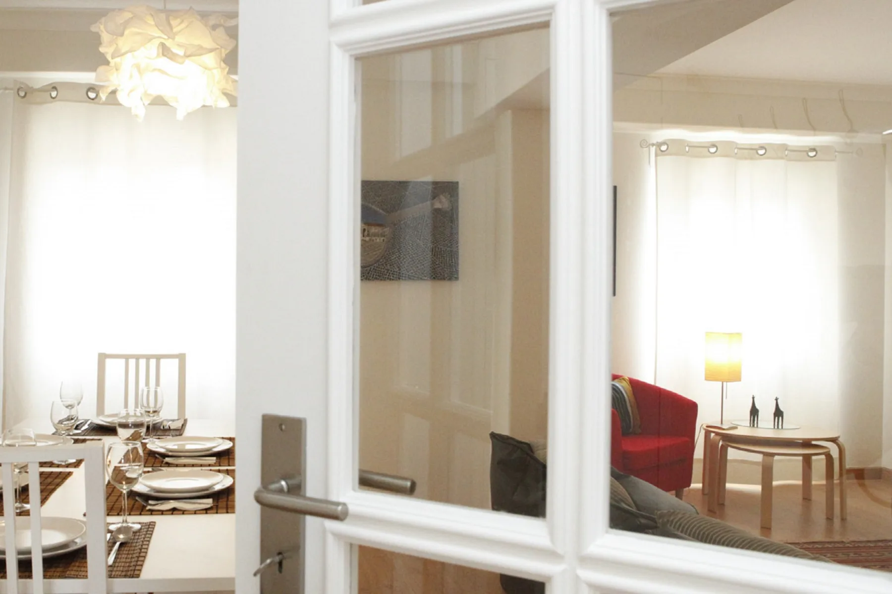 Un interior luminoso muestra un comedor junto a una sala de estar con asientos.
