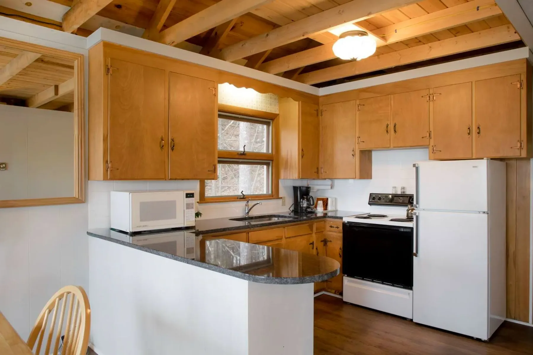 Kitchen with wood cabinets and appliances.