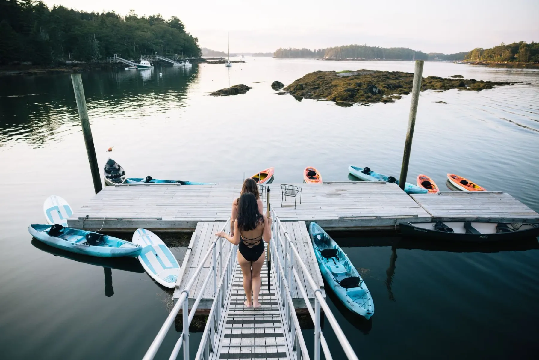 Guest approaching kayaks on a dock.