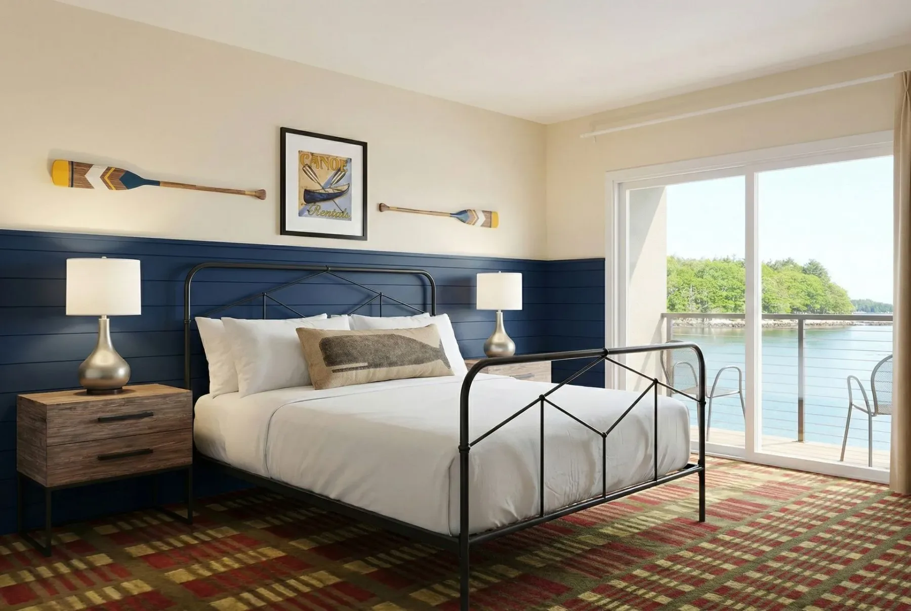 Bedroom with a door opening to a waterfront balcony.