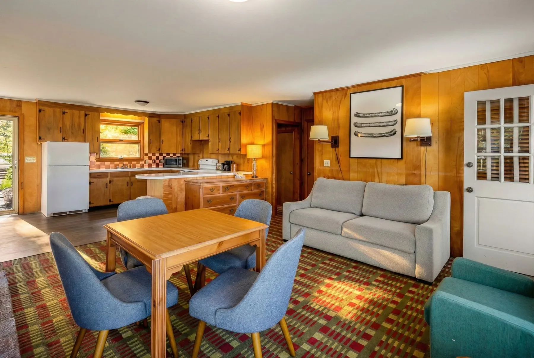 Interior with kitchen, dining area and seating.