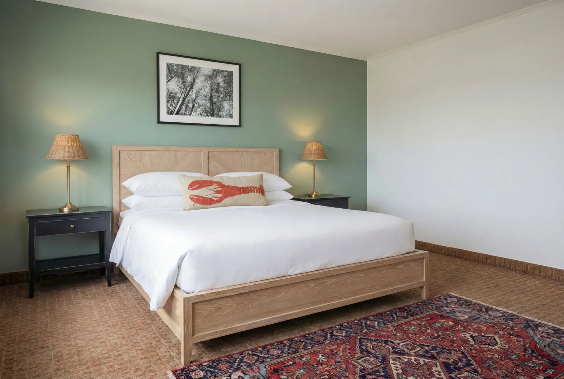 Bedroom with king bed and green accent wall.