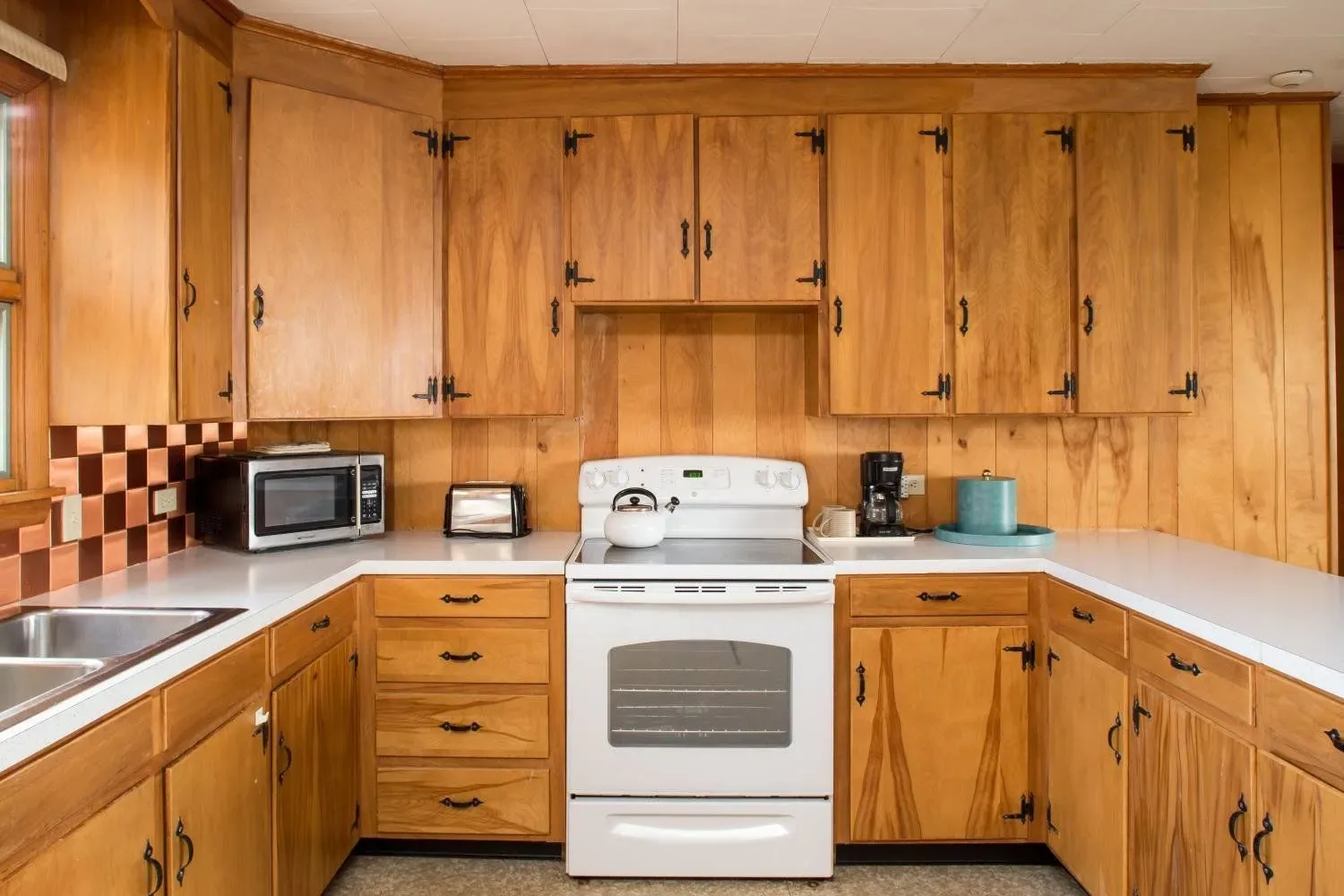 Kitchen with wood cabinets and stove.