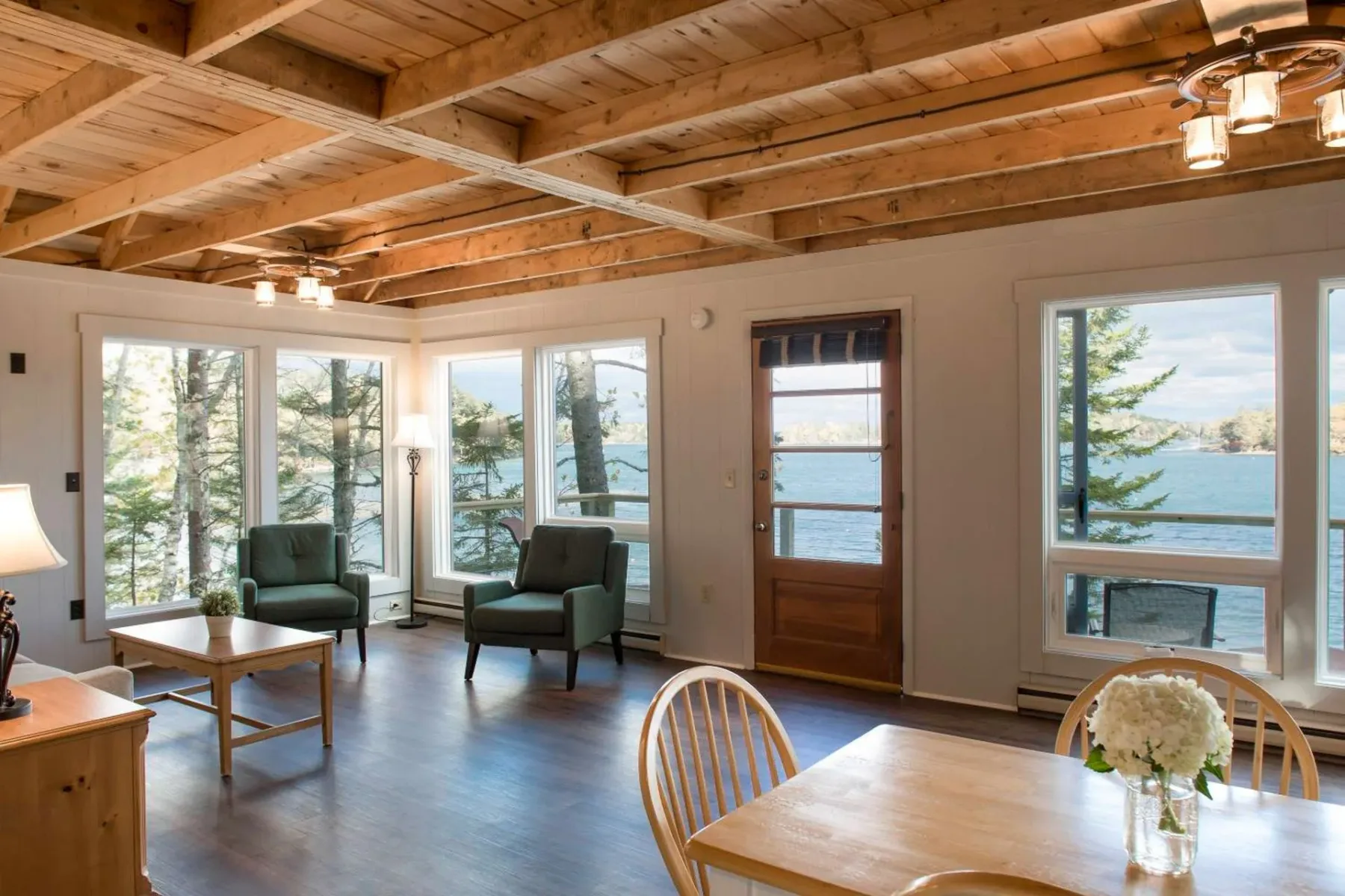 Bright living and dining area with water views.