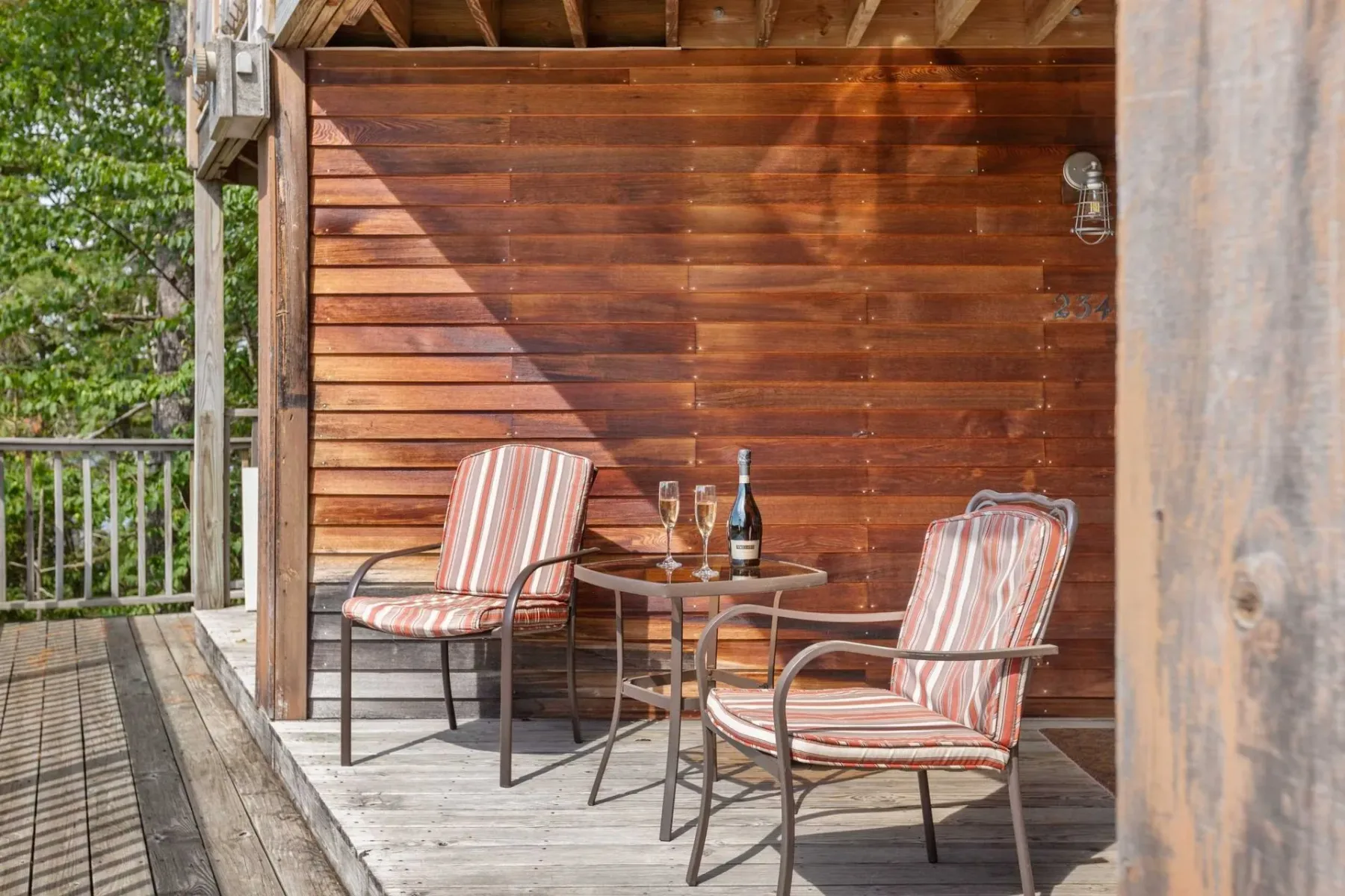 Chairs and table on a wooden deck.