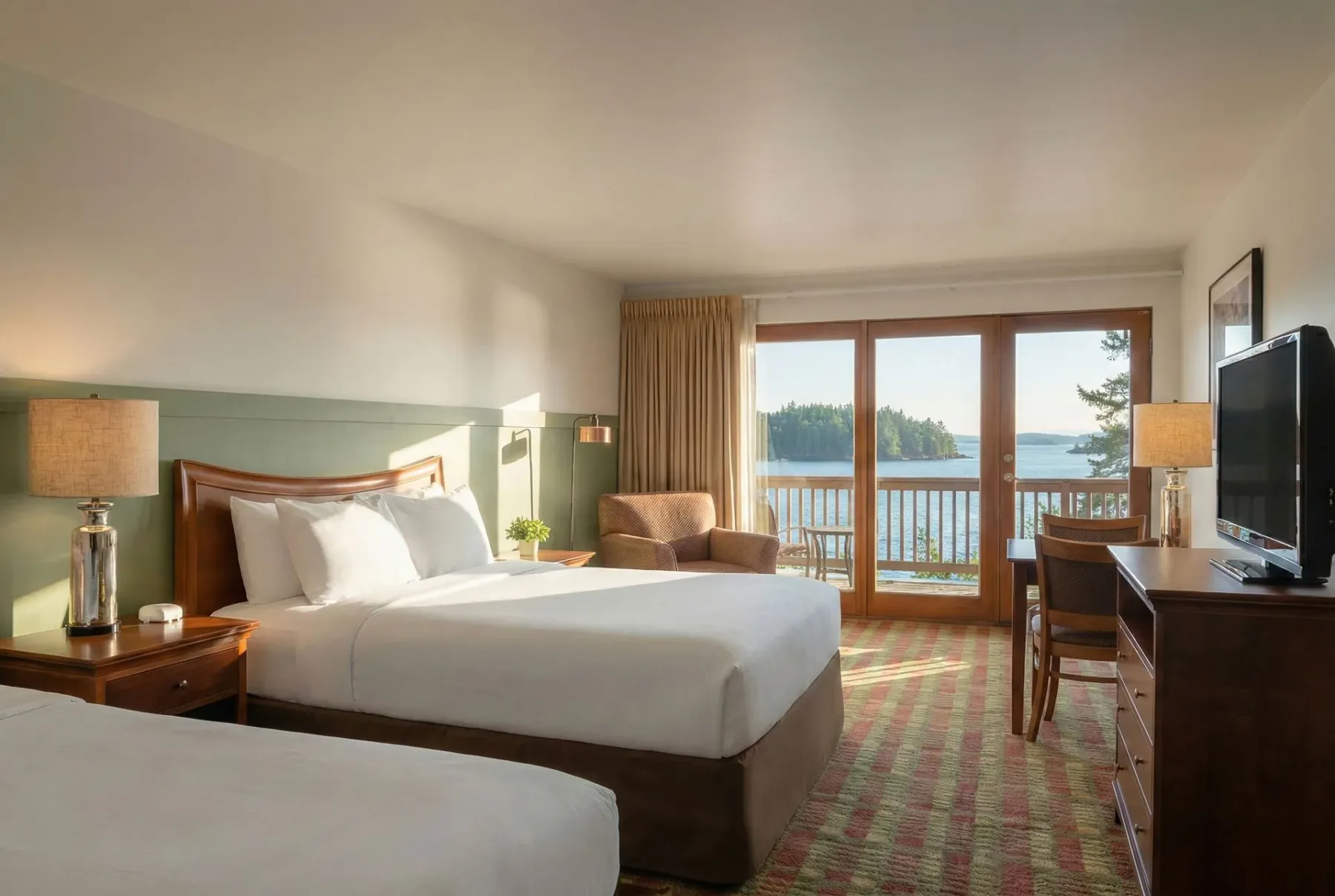Guest room with two beds and balcony.
