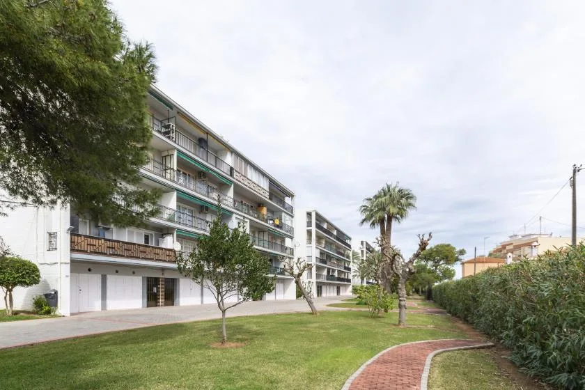 Apartment buildings line a landscaped lawn with a curved brick path.
