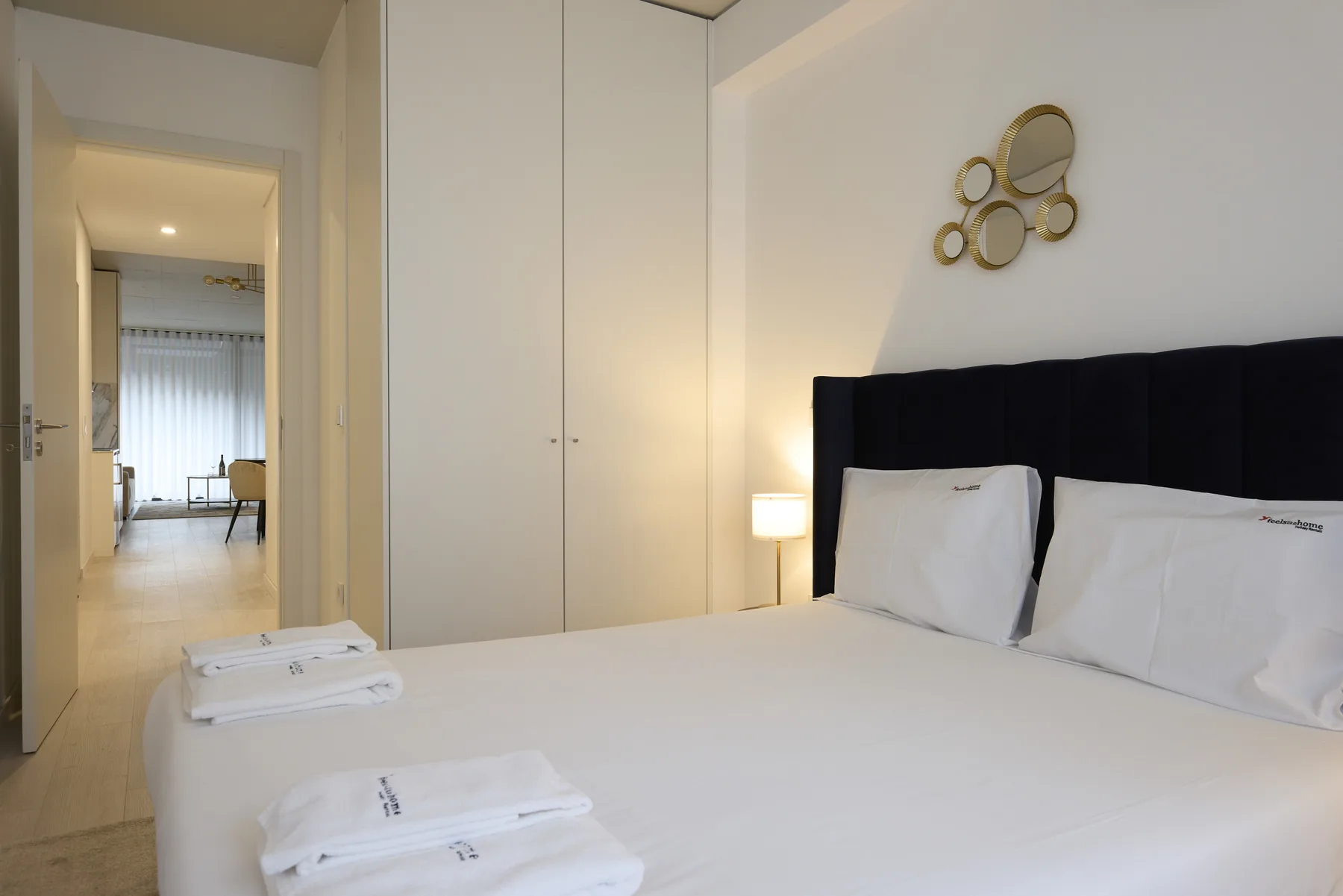 A bedroom with a neatly made bed and white towels.