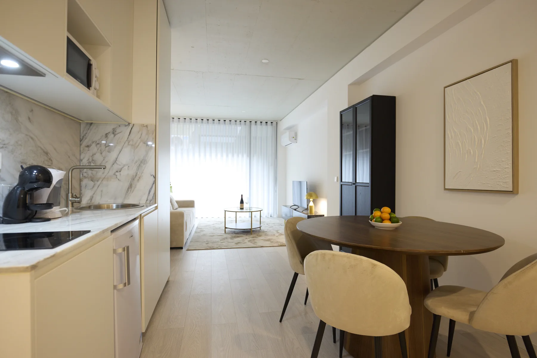 An open-plan kitchen and dining area with a table beside the living space.
