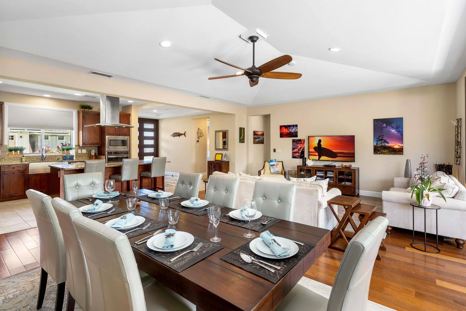 An open-plan dining and living area with a dining table and television.